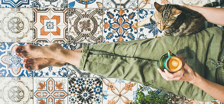 Femme et son chat assis sur un carrelage mosaïque